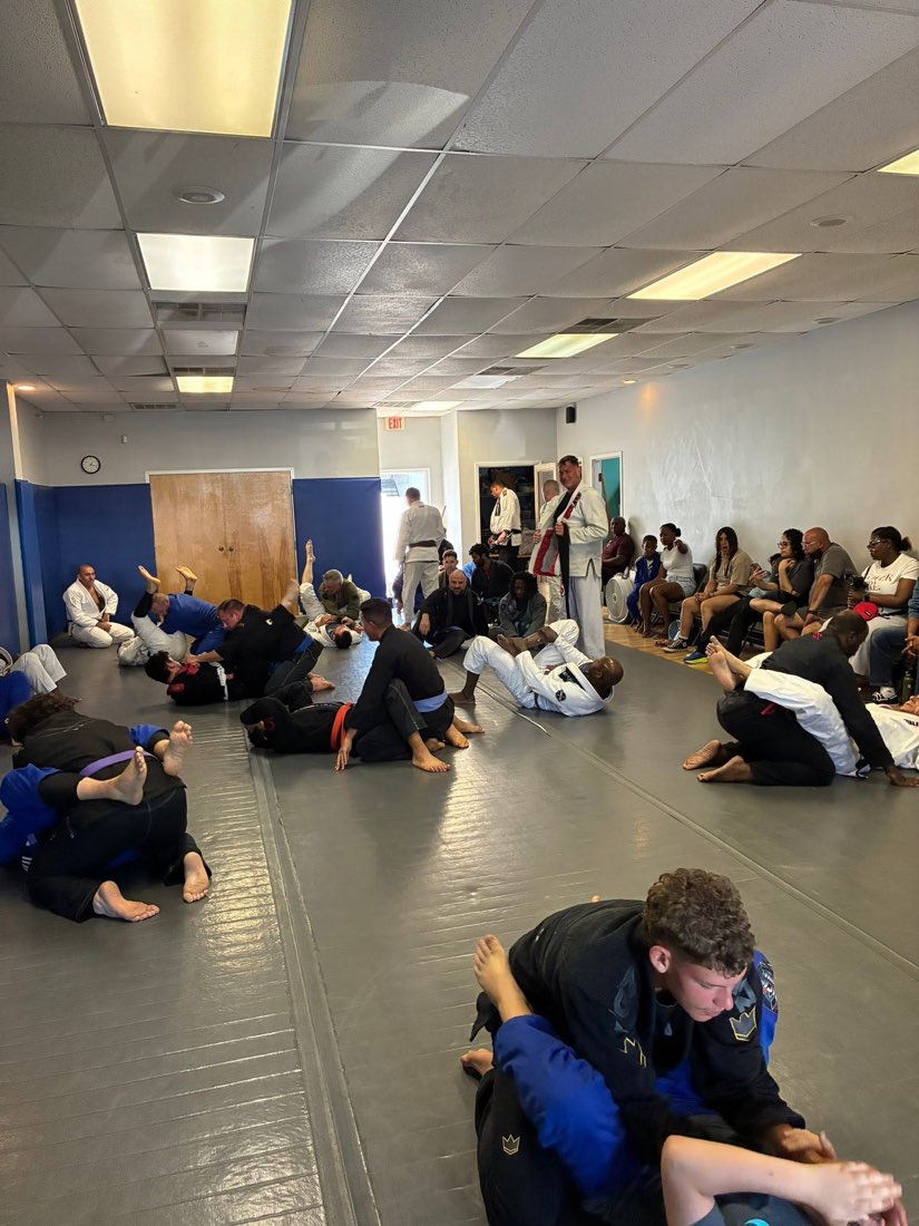 Adult students drilling and rolling during a Jiu-Jitsu class at Tampa Jiu-Jitsu