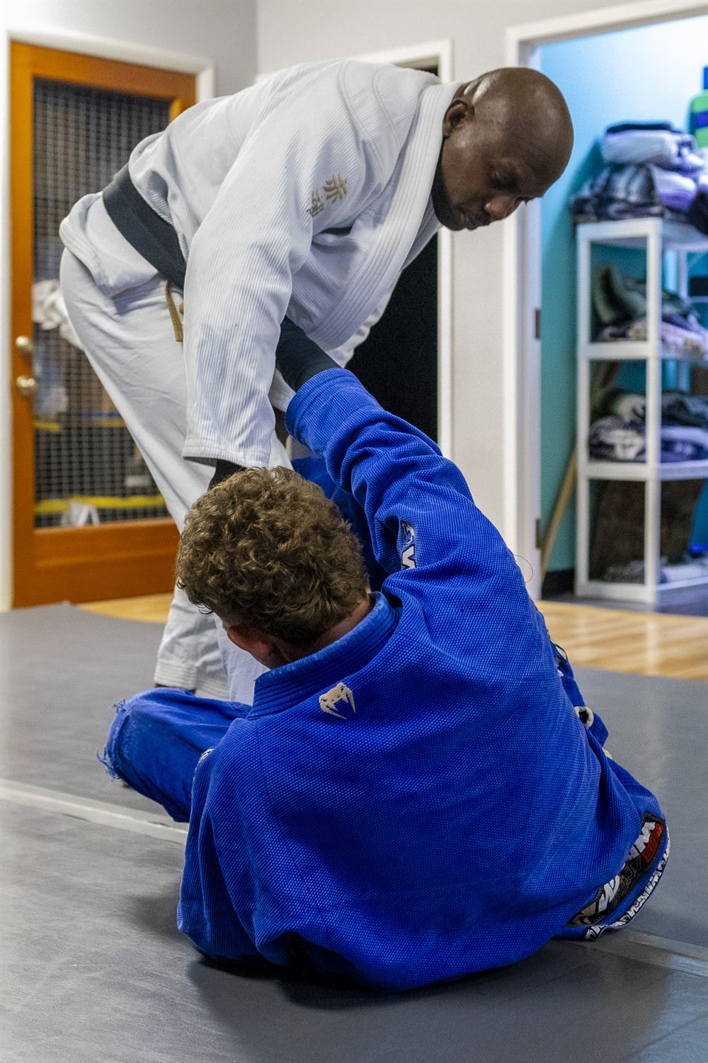 An adult student executing a takedown in Jiu-Jitsu training