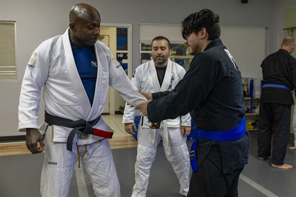 A black belt instructor coaching students at Tampa Jiu-Jitsu