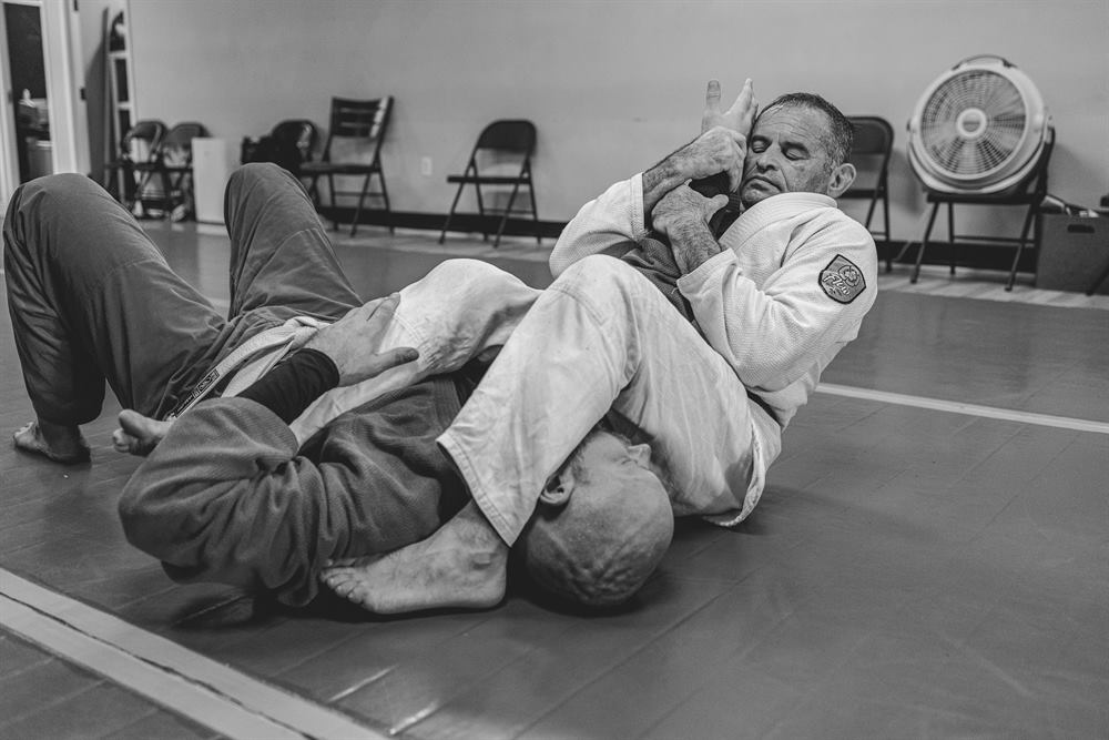 Two Tampa Jiu-Jitsu students working a submission on the mat