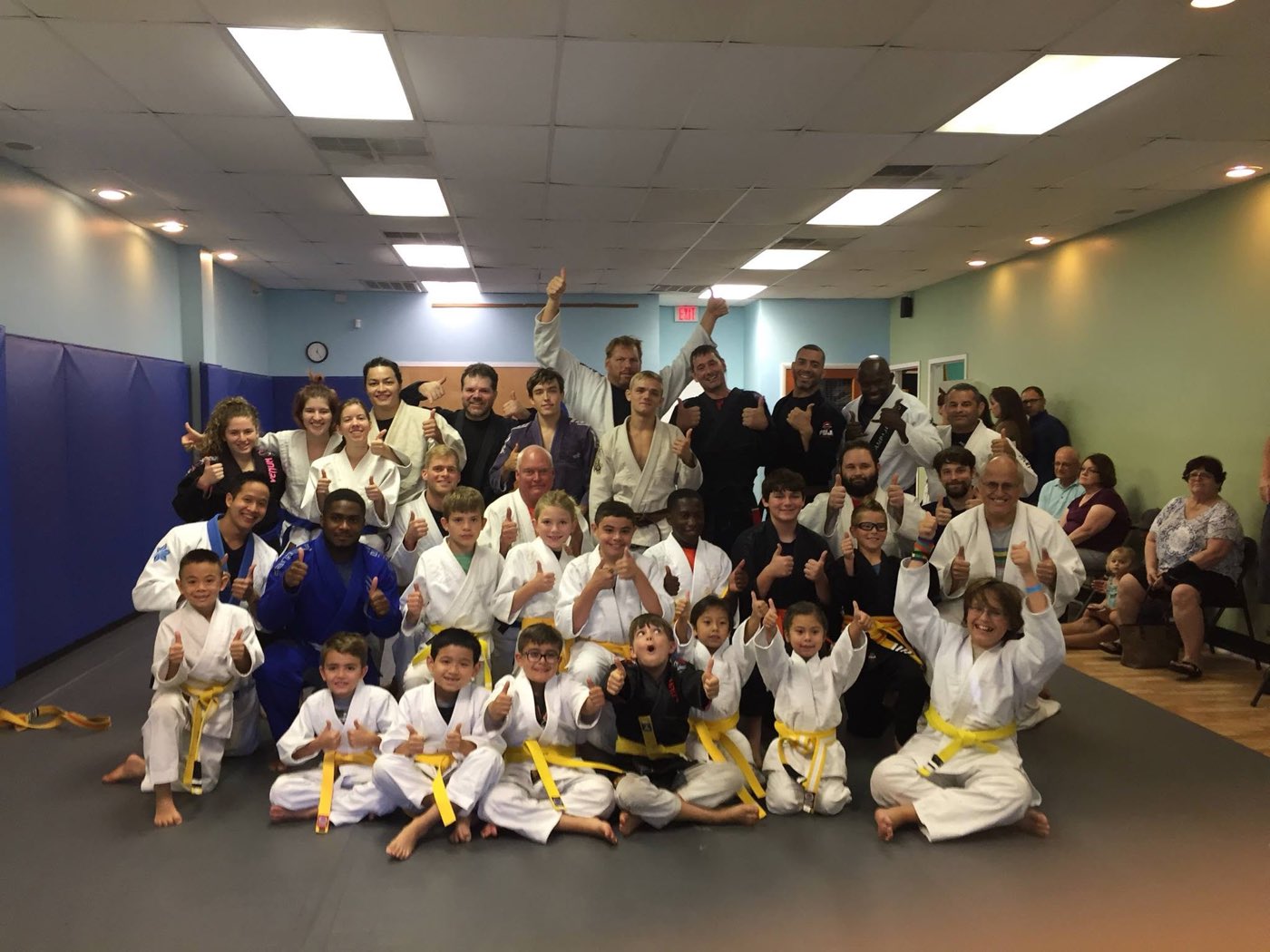 Kids, parents, and coaches together on the mats after a Tampa Jiu-Jitsu kids class