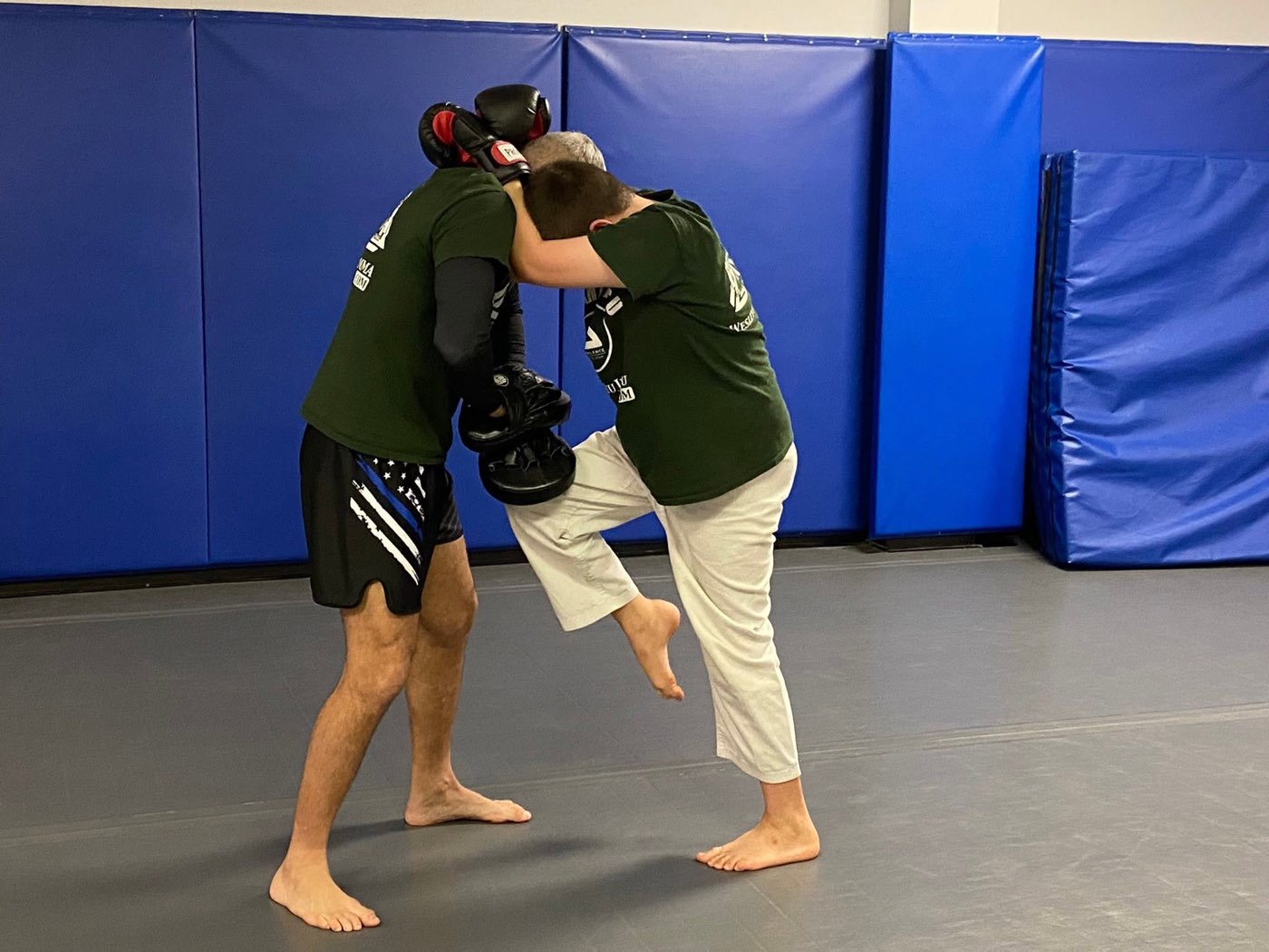 Two adult students working knees from the Muay Thai clinch